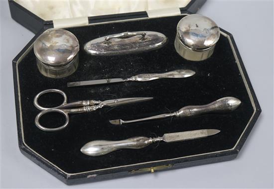 A cased 1920s silver mounted seven piece manicure set.